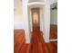 Long hallway with hardwood flooring, archways, and neutral paint at 9340 Sw 9Th Ter, Ocala, FL 34476