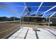 Screened in lanai features a tile floor and a view of the fenced backyard at 9340 Sw 9Th Ter, Ocala, FL 34476