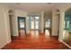 Spacious living room featuring hardwood flooring, arched doorways, and an abundance of natural light at 9340 Sw 9Th Ter, Ocala, FL 34476