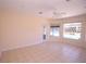 Living area featuring light tile flooring, a ceiling fan, and a view of the pool at 9340 Sw 9Th Ter, Ocala, FL 34476