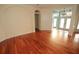 Spacious living room with hardwood floors, neutral walls, and a double front door entrance at 9340 Sw 9Th Ter, Ocala, FL 34476
