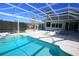 Private pool is encased in a screened-in lanai with patio space and a fenced yard at 9340 Sw 9Th Ter, Ocala, FL 34476