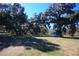 Picturesque land with mature oak trees providing ample shade; features a small storage building at 9340 Sw 9Th Ter, Ocala, FL 34476