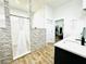 Modern bathroom with a walk-in shower, soaking tub, and quartz countertop at 9645 Se 61St Ter, Belleview, FL 34420