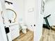 Small half bathroom with a toilet and vanity at 9645 Se 61St Ter, Belleview, FL 34420
