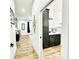 Elegant bathroom with dark vanity and a view of the hallway at 9645 Se 61St Ter, Belleview, FL 34420