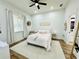 Bright bedroom featuring a queen bed and large window at 9645 Se 61St Ter, Belleview, FL 34420
