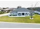 Single-story home with gray siding, gray roof, and a large front yard at 9645 Se 61St Ter, Belleview, FL 34420