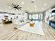 Open living area with hardwood floors, large sectional sofa, and kitchen views at 9645 Se 61St Ter, Belleview, FL 34420
