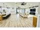 Open-concept living room and kitchen with hardwood floors and large windows at 9645 Se 61St Ter, Belleview, FL 34420