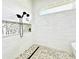 Walk-in shower with mosaic tile, built-in shelves, and rainfall shower head at 9645 Se 61St Ter, Belleview, FL 34420