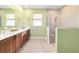Modern bathroom with dual vanity and walk-in shower at 9958 Sw 97Th Ln, Ocala, FL 34481