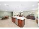 Open kitchen with large island, stainless steel appliances and views to Gathering room at 9958 Sw 97Th Ln, Ocala, FL 34481