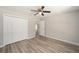 Secondary bedroom with double door closet and hardwood floor at 10120 Se 130Th St, Belleview, FL 34420