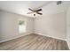 Bright bedroom with ceiling fan and wood-look flooring at 10120 Se 130Th St, Belleview, FL 34420