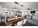 Open concept dining area with wood table and modern light fixture at 10455 Se 143Rd St, Summerfield, FL 34491