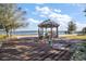 Lakeside gazebo with seating and lake views at 10455 Se 143Rd St, Summerfield, FL 34491