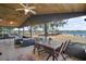 Covered patio with seating and lake view at 10455 Se 143Rd St, Summerfield, FL 34491