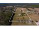 Aerial view showing home and expansive acreage with stables at 11130 W Highway 326, Ocala, FL 34482