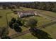 Aerial view of house and expansive property with fencing at 11130 W Highway 326, Ocala, FL 34482