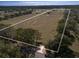 Aerial view of expansive land with mature trees and existing structures at 11130 W Highway 326, Ocala, FL 34482