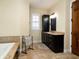 Bathroom boasts a large soaking tub and dark cabinetry at 11130 W Highway 326, Ocala, FL 34482