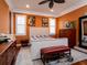 Guest bedroom with orange walls and a comfortable bed at 11130 W Highway 326, Ocala, FL 34482