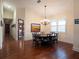 Elegant dining room featuring a round table, chandelier, and hardwood floors at 11130 W Highway 326, Ocala, FL 34482