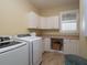 Laundry room with washer, dryer, and ample cabinetry at 11130 W Highway 326, Ocala, FL 34482