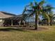 Screened pool and patio with palm trees and lush lawn at 11130 W Highway 326, Ocala, FL 34482