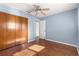 Light blue bedroom with wood floors and double door closet at 11250 Sw 79Th Ter, Ocala, FL 34476