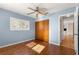 Light blue bedroom with wood floors and double door closet at 11250 Sw 79Th Ter, Ocala, FL 34476