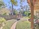 Landscaped backyard with brick pathway and pergola at 1209 Se 17Th Ave, Ocala, FL 34471