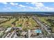 Aerial view of golf course, clubhouse, and pool at 13981 Se 86Th Cir, Summerfield, FL 34491