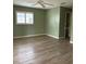 Spacious bedroom with light walls and wood-look flooring at 13981 Se 86Th Cir, Summerfield, FL 34491