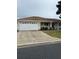 Exterior view of a single-story house with a two-car garage and driveway at 13981 Se 86Th Cir, Summerfield, FL 34491