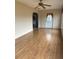 Living room featuring hardwood floors, a ceiling fan and access to other areas at 13981 Se 86Th Cir, Summerfield, FL 34491