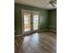 Living room with French doors leading to a sunroom at 13981 Se 86Th Cir, Summerfield, FL 34491