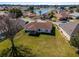 Aerial view of house, large backyard, and neighborhood lake at 17385 Se 110Th Ter, Summerfield, FL 34491