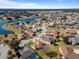 Aerial view of the property and its surroundings, including a lake at 17385 Se 110Th Ter, Summerfield, FL 34491