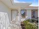 Inviting front porch with a white door and landscaping at 17385 Se 110Th Ter, Summerfield, FL 34491