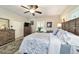 Large bedroom with a wooden bed frame, dresser, and a ceiling fan at 1758 Se 7Th St, Ocala, FL 34471