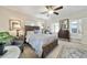 Bright bedroom with a wooden bed frame, nightstands, and a ceiling fan at 1758 Se 7Th St, Ocala, FL 34471