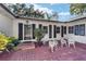 Brick courtyard with white metal chairs and lush greenery at 1758 Se 7Th St, Ocala, FL 34471