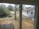 View of backyard with wooden deck and detached garage at 18782 Se 50Th St, Ocklawaha, FL 32179