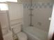 Clean bathroom with bathtub, toilet, and white cabinetry at 18782 Se 50Th St, Ocklawaha, FL 32179