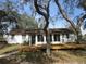 Front view of charming home with a wooden deck at 18782 Se 50Th St, Ocklawaha, FL 32179