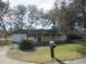 White house with covered patio, mailbox, and lush green lawn at 18782 Se 50Th St, Ocklawaha, FL 32179