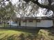 White single story home with covered patio and large yard at 18782 Se 50Th St, Ocklawaha, FL 32179