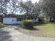 White single story home with covered patio and carport at 18782 Se 50Th St, Ocklawaha, FL 32179